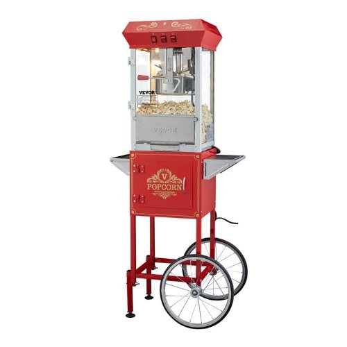 Machine &agrave; popcorn rouge mont&eacute;e sur un chariot &agrave; deux grandes roues &agrave; rayons, avec deux tablettes lat&eacute;rales et un coffre ferm&eacute;
